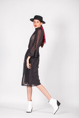 Portrait of a young model in polka dot dress, studio indoor