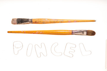 different used paintbrushes on white background