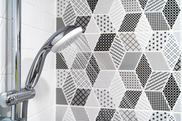 Shower with a flowing stream of water in the new bathroom with a European renovation close-up. 