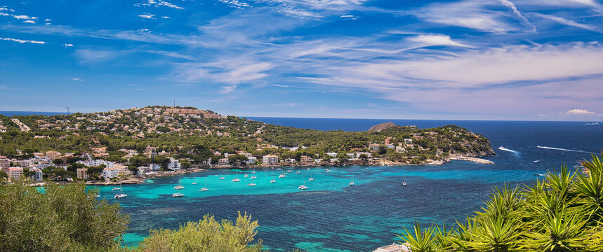 Panoramic image coastline of Santa Ponsa town in the south-west of Majorca Island. Located in the municipality of Calvia, moored yachts on the turquoise tranquil bay of Mediterranean Sea, Spain