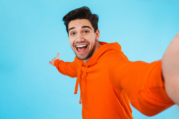 Portrait of a cheerful young man wearing hoodie