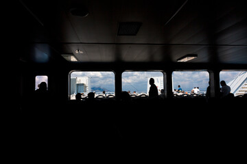 Backlight shot from inside the ferry that is about to arrive at the pier