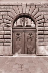 Old door in Budapest. Sepia toned vintage filter photo.