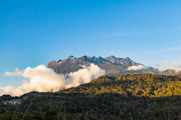 view of Mount Kinabalu emerges out from the clouds at near sunsets