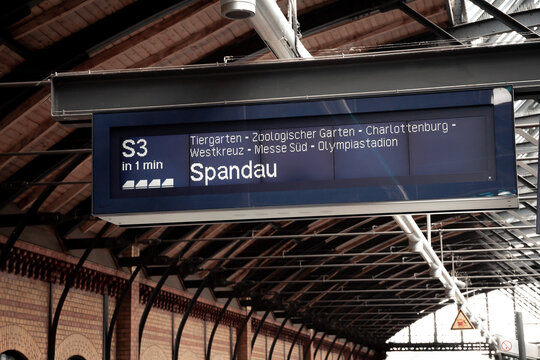 A train station sign showing the next train and its destinations on a subway station in Berlin, Germany