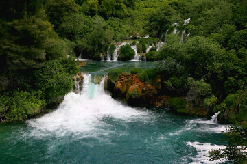 Fototapeta na wymiar Beautiful waterfalls in National Park Krka, Croatia. Krka is popular summer travel destination.