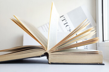 Open Book and News Pages. Business Literature and Newspapers. Concept for Information in Headlines and Articles