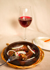 Georgian traditional food and cuisine Kupati and red wine, ghomi and cheese.