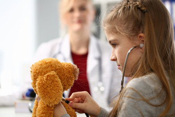 Close up of serious girl that playing with stethoscope