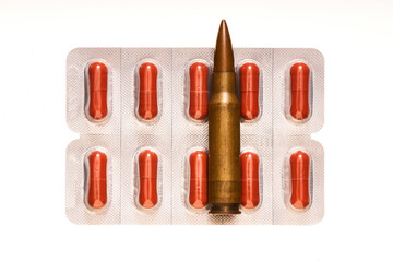 medicines and bullets on white background      