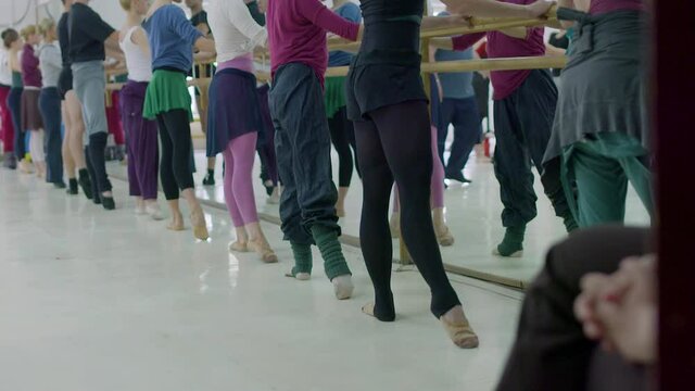 Editorial slow motion shot of ballet dancer in class during practice. Warm-up