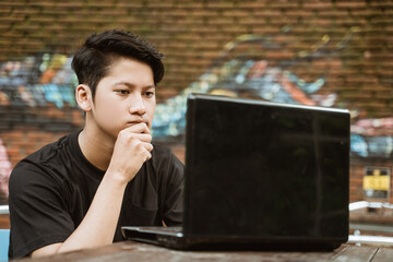 Freelance workers seriously use laptops for working outdoors in coworking space