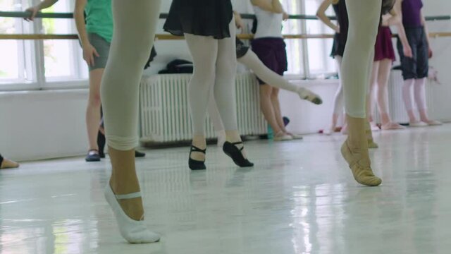 Editorial slow motion shot of ballet dancer in class during practice. Warm-up