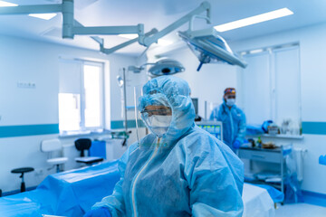 Women doctor wearing protective suit to fight coronavirus pandemic covid-2019. Protective suit, goggles, gloves, respirator.