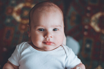 portrait of a little boy. cute baby. three month old boy smiling. baby with a pacifier