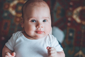 portrait of a little boy. cute baby. three month old boy smiling. baby with a pacifier