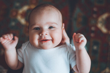 portrait of a little boy. cute baby. three month old boy smiling. baby with a pacifier