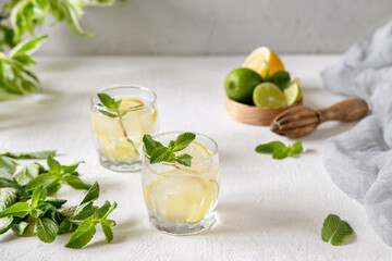 Two glasses homemade cold refreshing lemonade with mint.