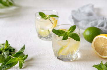 Two glasses homemade cold refreshing lemonade with mint.