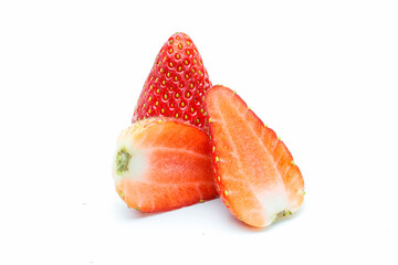 Fresh strawberries and strawberry slices on a white background.