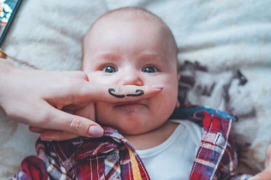 little boy with a painted mustache. funny children's photo. baby with a mustache