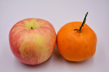 one apple and orange on the white background