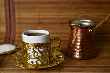 gold cup for coffee on a light background