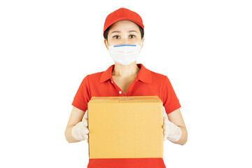 Fototapeta na wymiar Delivery woman in red uniform isolated on white background.Courier in protective mask and medical gloves holding cardboard box. Receiving package under quarantine, disease outbreak
