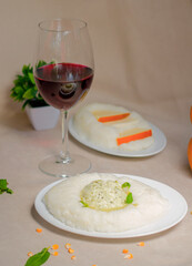 Georgian traditional food and cuisine ghomi with cheese and red wine.
