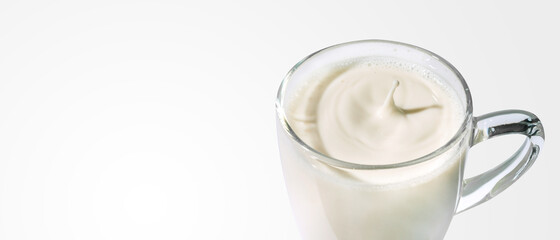 Drops of milk in a clear glass with clipping path.
