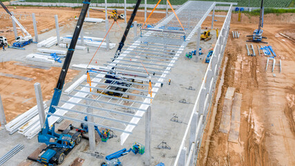 Aerial view construction worker instalation steel roof structure by mobine crane