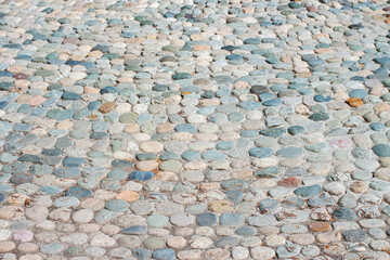 Colorful paved road with little different colors round stones