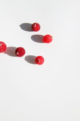 Cranberries on with background with strong shadows. Trendy minimal food concept. Healthy ingredients, flat lay