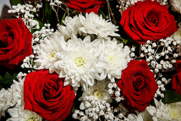 top view closeup elegant bouquet of large red roses and white velvet daisies