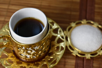 gold cup for coffee on a light background