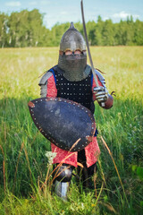 A medieval Central Asian warrior, a nomad in 14th-century armor, stands in a defensive or attacking...