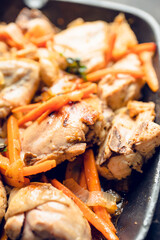 Roasted chicken on the pan with carrot, onion, gralic and other spices. Selective focus. Shallow depth of field. 