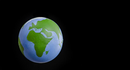 Drawn Earth globe isolated on black background. Empty space for text