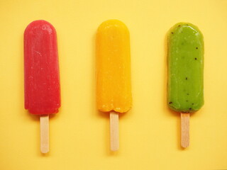 Colored fruit ice cream made from kiwi, lemon and berries