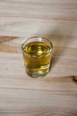 glass of  whiskey on a wooden table
