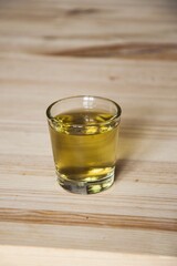glass of  whiskey on a wooden table