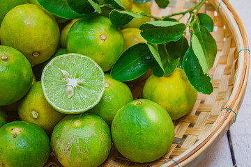Lemon in basket on white wood.