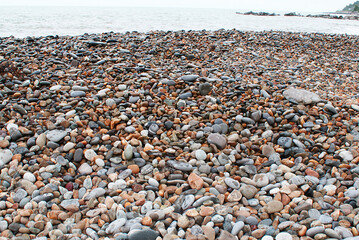 Stones by the sea, pebbles on the beach, sea coast.