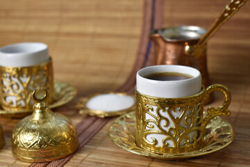gold cup for coffee on a light background