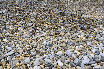 Stones by the sea, pebbles on the beach, sea coast.