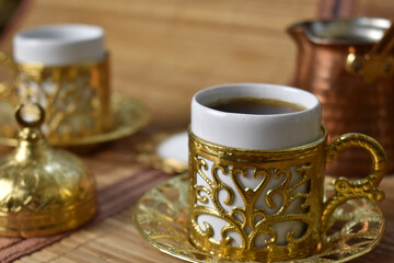 gold cup for coffee on a light background