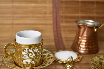 gold cup for coffee on a light background