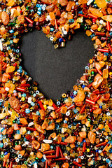 Love, Valentine theme, heart, relations. A mix of real amber and spun beads on black paper.