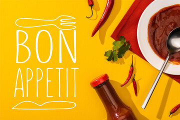 Top view of tomato sauce with hot chili peppers and cilantro on yellow background, bon appetit...
