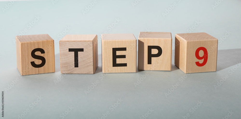 Poster step by step concept. step 9 nine text on wooden cube blocks on blue grey table